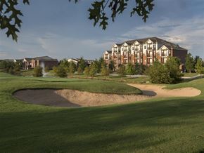 Fayetteville apartment for rent - a golf course with an apartment building in the background