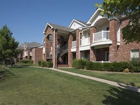Fayetteville apartment for rent - an apartment building with a green lawn and a sidewalk