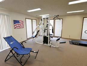 Fayetteville apartment for rent - a gym with a chair and equipment in a room