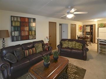 Fayetteville apartment for rent - a living room with leather couches and a coffee table