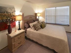 Fayetteville apartment for rent - a bedroom with a bed and a dresser with lamps