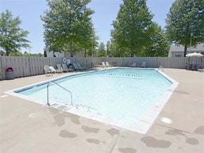 Fayetteville apartment for rent - our apartments have a resort style pool with chairs and trees