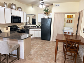 Bentonville apartment for rent - a kitchen with a dining table and a refrigerator