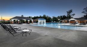 Conway apartment for rent - a swimming pool with chairs around it at night