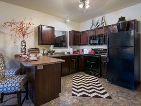 Canton apartment for rent - a kitchen with a center island and a black refrigerator