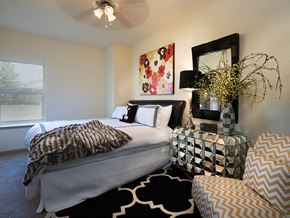 Canton apartment for rent - a bedroom with a bed and a chair and a mirror