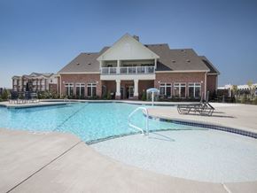 Oklahoma City apartment for rent - a swimming pool with a building in the background