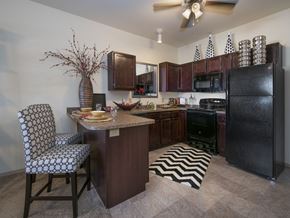 Oklahoma City apartment for rent - a kitchen with a island and a black refrigerator