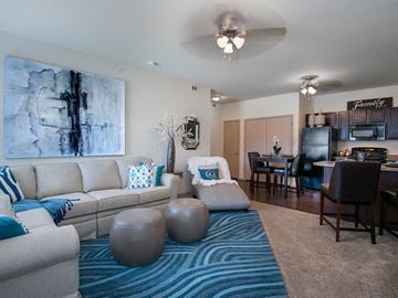 Oxford apartment for rent - an open living room and dining room with a couch and a chair and a table