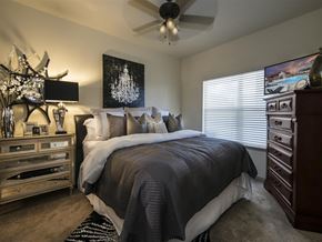 Bentonville apartment for rent - a bedroom with a bed and a ceiling fan