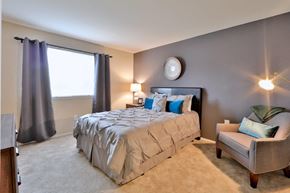 Nottingham apartment for rent - a bedroom with a bed and a chair and a window