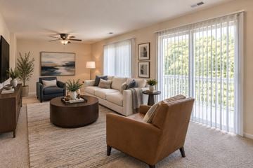 Catonsville apartment for rent - A living room with a brown chair and a white couch.
