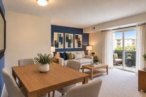 Glen Burnie apartment for rent - A dining room with a wooden table and chairs.