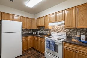 Glen Burnie apartment for rent - a kitchen with white appliances and wooden cabinets