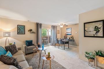 Baltimore apartment for rent - A living room with a grey couch, a coffee table, and a painting on the wall.