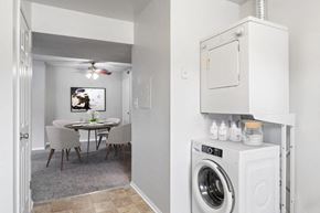 Westminster apartment for rent - a white laundry room and dining room with a washing machine