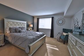 Westminster apartment for rent - a bedroom with a bed and a chair and a window