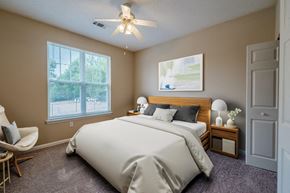 Garner apartment for rent - a bedroom with a bed and a ceiling fan