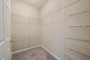 Garner apartment for rent - a spacious closet with white shelves and a door