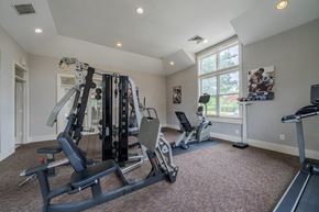 Garner apartment for rent - a home gym with exercise equipment and a window