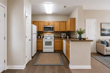 Raleigh townhouse for rent - A kitchen with wooden cabinets and a white oven.