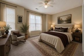 Raleigh townhouse for rent - A bedroom with a bed, chair, and a painting on the wall.