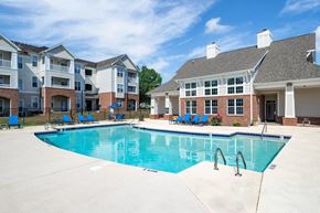 Raleigh townhouse for rent - A swimming pool in front of apartment buildings.