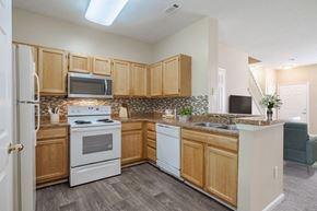 Raleigh townhouse for rent - A kitchen with a white stove and white oven.