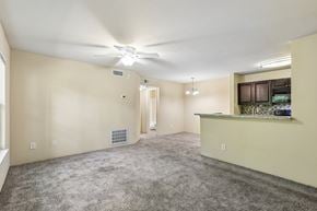 York apartment for rent - A spacious room with a ceiling fan and a counter with a microwave.