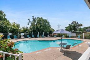 York apartment for rent - a swimming pool with chairs and an umbrella