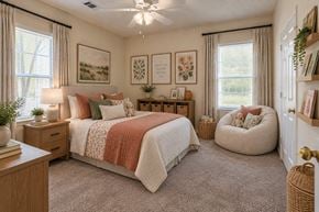 Lexington apartment for rent - A bedroom with a large bed, a window with curtains, and a ceiling fan.