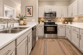 Lexington apartment for rent - A kitchen with white cabinets and a stainless steel oven.