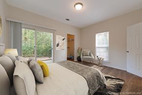 Rock Hill apartment for rent - a bedroom with a large bed and a chair and a window