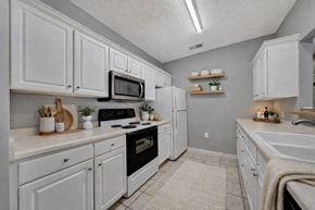 Lincoln apartment for rent - A kitchen with white cabinets and appliances.