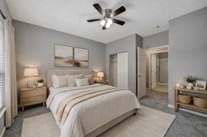 Lincoln apartment for rent - A bedroom with a large bed and a ceiling fan.