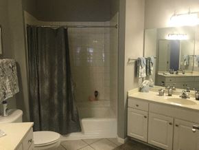 Lincoln apartment for rent - A bathroom with a toilet, sink, and shower.