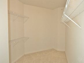 Lincoln apartment for rent - Empty room with white shelves and a fan on the ceiling.