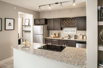 Bellevue apartment for rent - A kitchen with a granite counter top and a bistro sign above the sink.