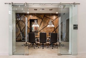 Boulder apartment for rent - a conference room with glass doors and a table with chairs