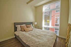 Seattle apartment for rent - a bedroom with a bed and a large window