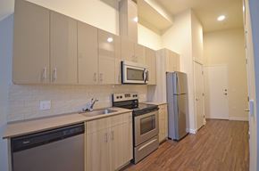 Seattle apartment for rent - a kitchen with stainless steel appliances and white cabinets