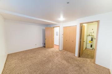 Seattle apartment for rent - a living room with carpet and a door to a bathroom
