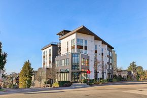 Seattle apartment for rent - Exterior view of the modern 4400 Alaska apartment building with mixed facade and blue sky in Seat...