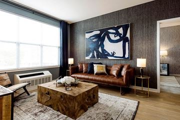 Bloomfield apartment for rent - a living room with a leather couch and a coffee table