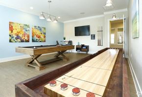 Clayton apartment for rent - a game room with a shuffleboard table and a television