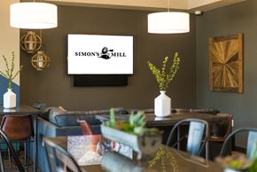 Edgewood apartment for rent - a dining room with tables and chairs and a tv on the wall