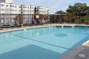 Worcester apartment for rent - a swimming pool with chairs and a fence around it