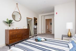 Worcester apartment for rent - a bedroom with a bed and a dresser with a mirror