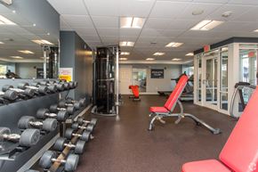 Worcester apartment for rent - a gym with weights and other equipment on the floor and a glass door
