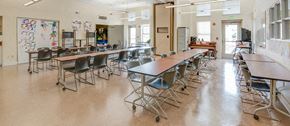 Edgewood townhouse for rent - a large classroom with desks and chairs in a school building